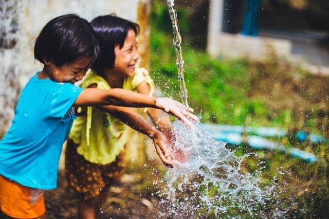 sisters playing with water