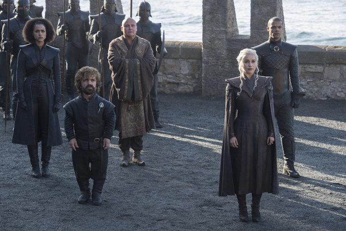 Daenerys Targaryen with her group of trusted advisors prepares to meet someone important in a scene from Game of Thrones Season 7