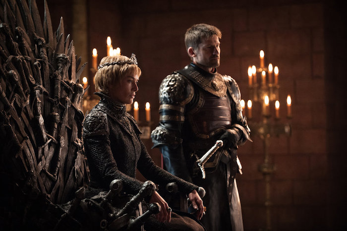A scene from King's Landing showing Queen Cersei on the Iron Throne flanked by Jaime Lannister
