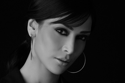 Supermodels Anupama Verma with a cigarette in her hand, her face captured.