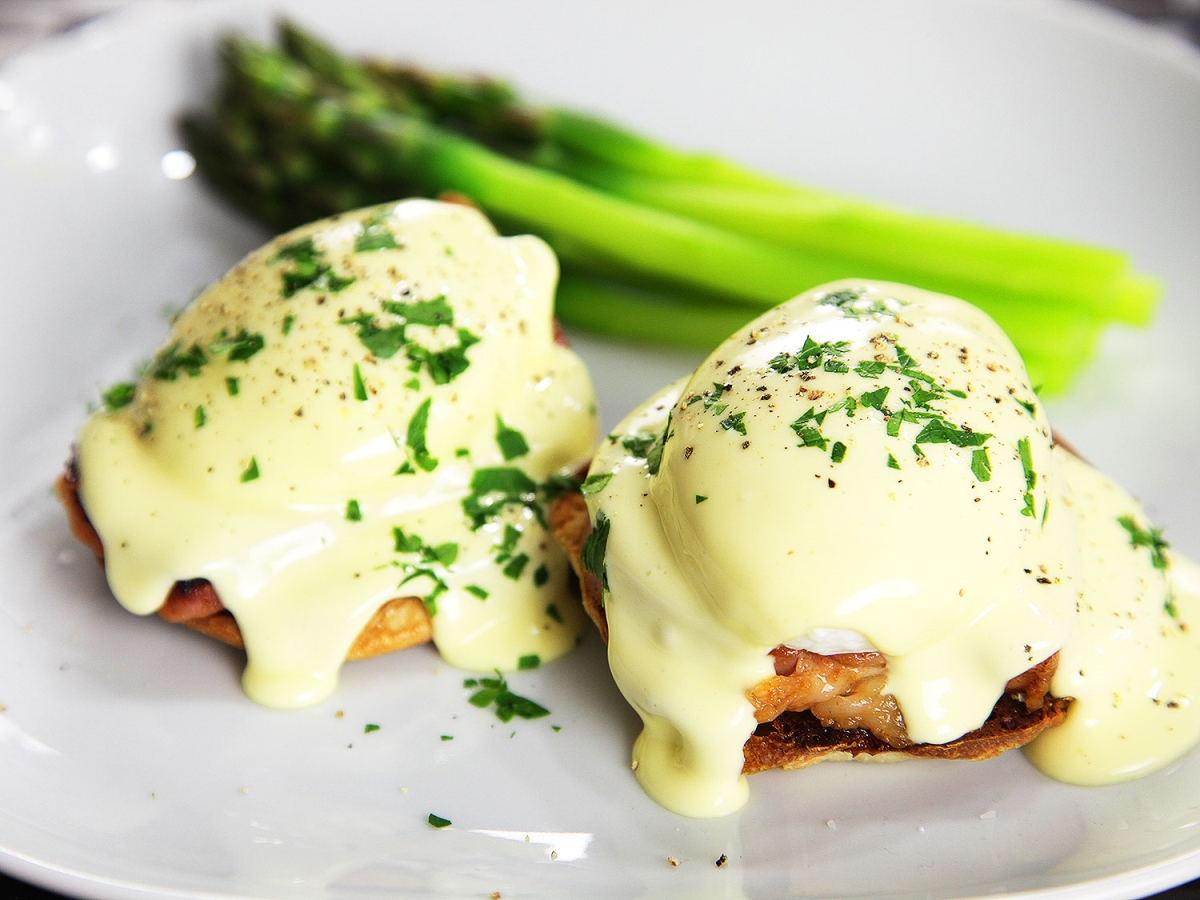 Hollandaise sauce served on eggs Benedict. Dutch sauce served on eggs Benedict